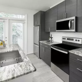 Kitchen with granite countertops and stainless steel appliances at Camden Monument Place in Fairfax, VA