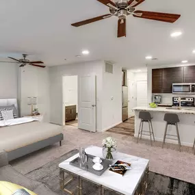 Kitchen and bedroom in studio floor plan at Camden Monument Place apartments in Fairfax, VA