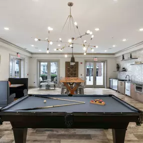 Resident lounge with pool table and entertaining kitchen at Camden Monument Place apartments in Fairfax, VA