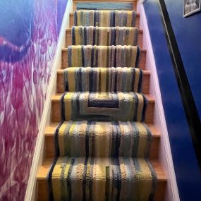 An ordinary rug turned into a stair runner.