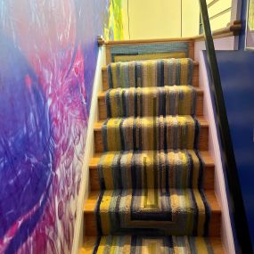 An ordinary rug turned into a stair runner.