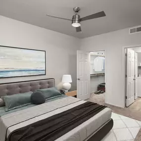 Bedroom with lighted ceiling fan, ensuite bathroom, and walk-in closet