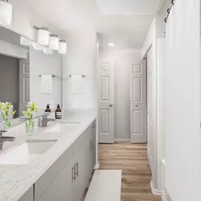 Contemporary bathroom with dual vanity white quartz countertop, gray cabinets, curved shower rod, and wood-like flooring