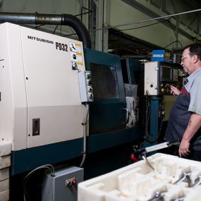 Employee running tests with a laser machine.