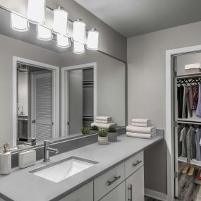 Contemporary midrise apartment bathroom with single sink and walk in closet