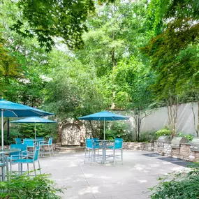 Outdoor grilling area with covered seating and serenity fountain