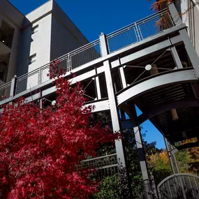 Outdoor walkway from covered parking garage to midrise apartments