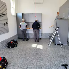 We can turn even an ordinary, small garage into an organization dream come true! In addition to the durable and beautiful Epoxy floor, we installed a sturdy and spacious workbench, garage cabinets and handy slat wall. This little garage now boasts a place for everything and everything in it's place