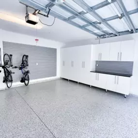 Custom Garage Makeover with Epoxy Flooring and Storage Cabinets – Southern Maine  This custom garage transformation features everything today’s homeowner needs: a seamless epoxy garage floor coating, full-height garage storage cabinets, wall-mounted bike racks, and a durable slatwall organization sy