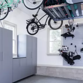 Clear the Clutter. Elevate Your Garage.  Tired of tripping over bikes, gear, and golf bags? Our custom garage storage systems are designed to get everything off the ground — and out of your way.  From heavy-duty overhead racks to vertical bike hooks, slatwall organization, and tall cabinets, we tran