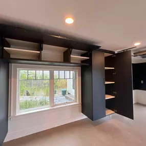 ✨ Garage Makeover in Southern Maine | Custom Cabinets in Mysterious Finish + Epoxy Floor in Biscuit ✨  Looking for a garage that’s as beautiful as it is functional? This recent garage makeover in Southern Maine features our sleek cabinet finish, Mysterious, paired with a durable epoxy garage floor in Biscuit.  This space now has custom garage cabinets designed around windows for maximum storage and natural light, floor-to-ceiling organization to keep tools, sports gear, and seasonal items off th