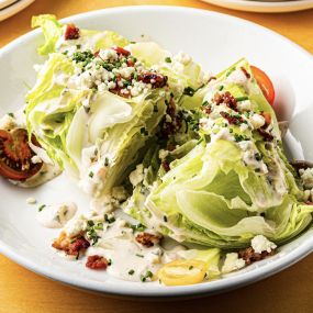 Wedge salad with crispy bacon, point reyes blue, tomato, ranch