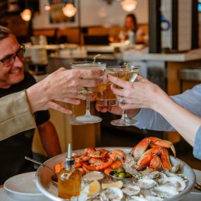 Cheers over fresh oysters and sustainable seafood