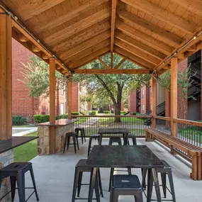 Covered pavilion with seating next to the volleyball court at Camden Addison