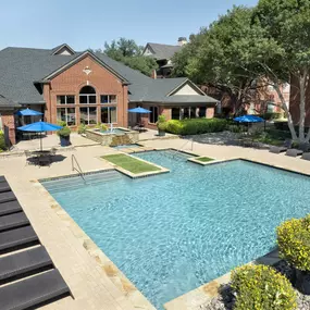 Resort-style pool lower level lined with lounge chairs at Camden Addison apartments in Addison, TX