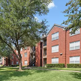 Building exterior with greenspace in front at Camden Addison