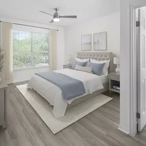 Bedroom with wood-style flooring, ceiling fan, and ensuite bathroom at Camden Addison apartments in Addison, TX