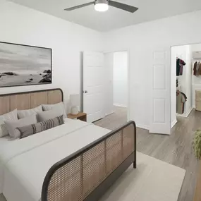Bedroom with wood-style floors, ceiling fan, and walk-in closet at Camden Addison apartments in Addison, TX