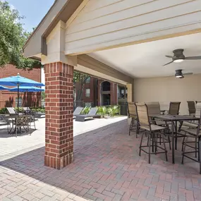 Outdoor, covered poolside lounge at Camden Addison apartments in Addison, TX