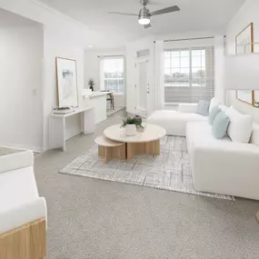 Open living room with carpet and private balcony at Camden Addison apartments in Addison, TX