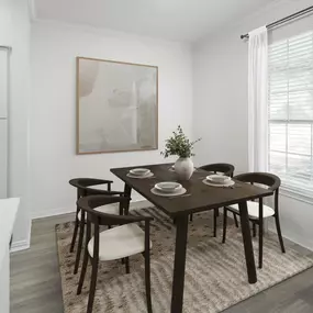 Dining area with wood-style flooring and large window at Camden Addison apartments in Addison, TX