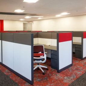 cubical in an office with patterned carpet and red accents Designed by marathon
