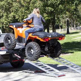 Mad Ramps loading four wheeler on flatbed truck