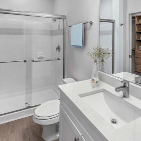 Bathroom with white quartz countertops and walk in shower