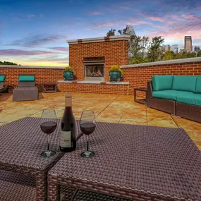 Rooftop terrace with lounge seating, fireplace, and skyline views