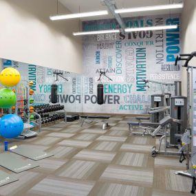 24 hour fitness center with strength training machines free weights and yoga equipment
