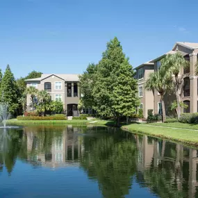 Building exterior showing exterior stairwells and picturesque lake