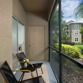 Screened patio overlooking community landscaping and lake