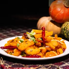 Spicy Prawn with Chips in a white round plate on a table at Karamay, London