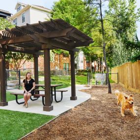 Onsite dog park with seating and agility equipment at Camden Heights Apartments in Houston, TX