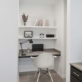 Built-in Desks with concrete-look countertops and wood-shelving at Camden Heights Apartments in Houston, TX