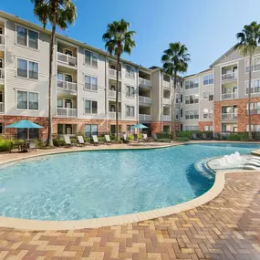 Resort-style swimming pool with water features and sun loungers at Camden Heights Apartments in Houston, TX