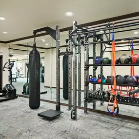 24-hour fitness center with cardio equipment and free weights at Camden Heights Apartments in Houston, TX