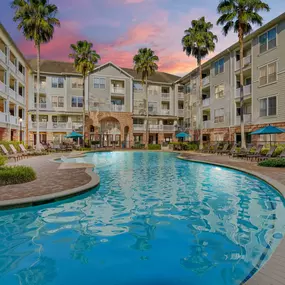 Resort-style swimming pool at dusk at Camden Heights Apartments in Houston, TX