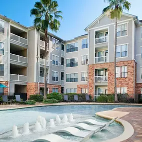 Resort-style swimming pool with Sun Loungers and Tanning Decks at Camden Heights Apartments in Houston, TX