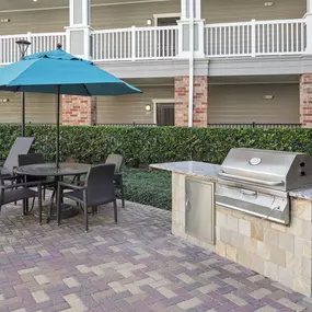 Outdoor grilling by the resort-style pool with dining at Camden Heights Apartments in Houston, Tx