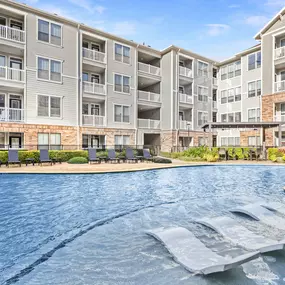 Resort-style swimming pool with water features and sun loungers at Camden Heights Apartments in Houston, TX