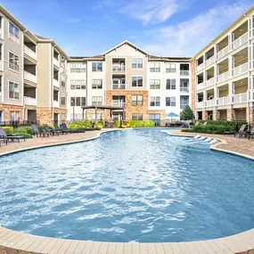 Resort-style swimming pool with Sun Loungers and Tanning Decks at Camden Heights Apartments in Houston, TX