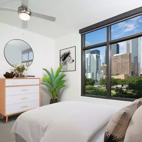 Bright contemporary finishes bedroom with downtown view