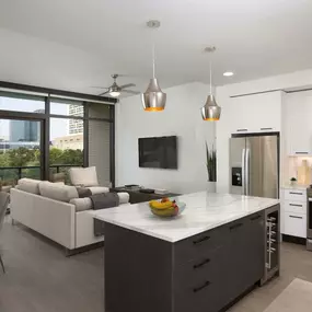 Bright contemporary finishes kitchen with wine and drink fridge and open concept floor plan