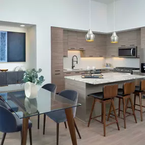 Warm modern finishes kitchen with stainless steel appliances and kitchen island