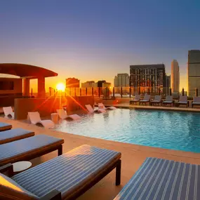 Swimming pool at sunset with downtown views