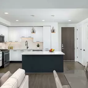 Bright contemporary finishes kitchen with island and gas range and goose neck faucet