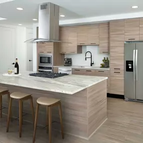 Warm modern finishes kitchen with quartz countertops stainless steel appliances and large kitchen islands