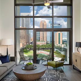 Warm modern finishes living room with downtown views