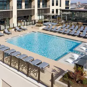 Swimming pool with lounge chairs and tanning deck